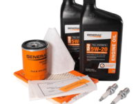 Generac maintenance kit for 11kw generator, available at Kirby Vacuum Supply, featuring two bottles of Generac 5W-30 Full Synthetic Engine Oil, one Generac oil filter, two spark plugs, a funnel, and a cleaning cloth, all essential for Generac generator maintenance, neatly arranged on a white background.